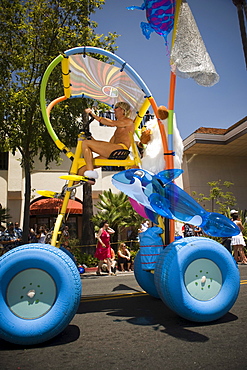 A unique bicycle at a parade in Santa Barbara. The parade features extravagant floats and costumes.