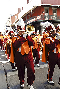 High school marching band at a Mardi Gras Parade in the French Quarter.