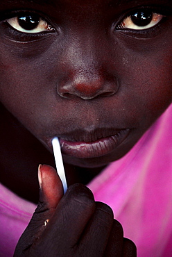 A portrait of an African kid enjoying his sweet candy in Mozambique.