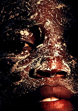 A portrait of a woman using M'siro, a traditional cosmetic on Mozambique Island, Mozambique.