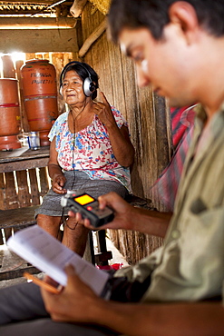 An Oro Win elder works with a linguist as he studies and records their language, Sao Luis Indian Post, Amazon Basin, Brazil.