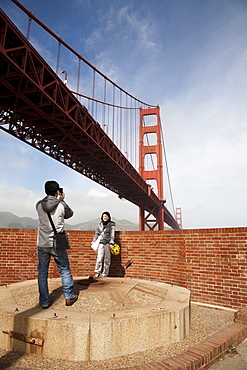 A young couple takes photos as they explore Fort Point in San Francisco. Feb. 2010