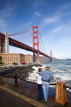 A couple gazes at the Golden Gate Bridge near Fort Point in San Francisco. Feb. 2010