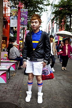 Portrait of a young man shopping in Ximending's pedestrian area, Taipei, Taiwan, October 30, 2010.