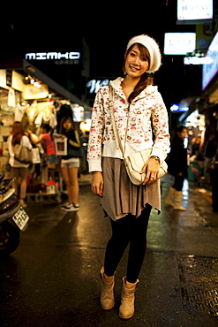 Portrait of a young woman by her clothing stall at the Shida Road Night Market, Taipei, Taiwan, November 5, 2010.