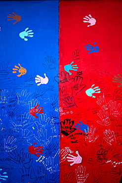 Painted hand prints and messages adorn the remains of the Berlin Wall. Germany.