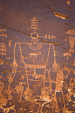 These Butler Wash Petroglyphs along the San Juan river are excellent examples of Indian petroglyphs. The large, square-shouldered figures are believed to be Kachinas, or gods, who are given rank by the stripes over their heads and may be seen to be giving speeches by the sound waves marked beside their heads.