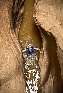 Anne Bogen wades through water in Cheesebox Canyon, Utah.