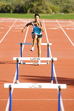 Brenda Taylor training and running hurdles on the track at the Olympic Training Center in San Diego, California.