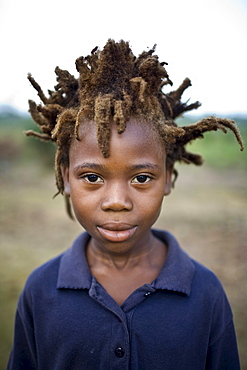 Portrait of a young african boy with wild spiky hair.