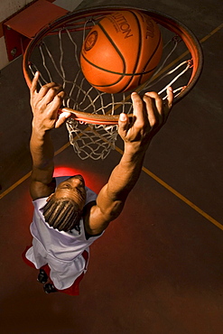 Clark College basketball player Markeith Brown slam dunks ball in Portland, Oregon.