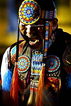 A Native American man participates in a dance at a powwow in Mesa Verde, Colorado.