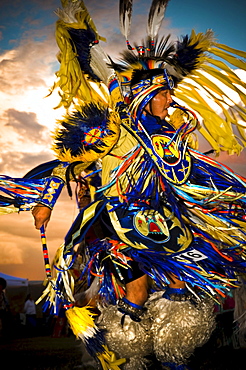 A Native American man participates in a dance at a powow in Mesa Verde, Arizona.