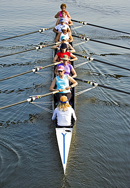 Members of the Saugatuck Rowing Club in Westport, Connecticut show how they can coordinate their rowing efforts to drive their scull upriver on a sunny June morning. The coxswain seated in the stern of the boat helps the team time their oar strokes and gives them words of encouragement.