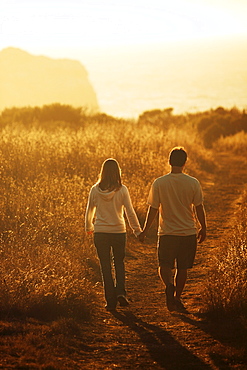 Blair and Jamie Salling hold hands while walking into the sunset in Big Sur, California.