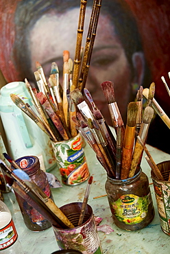 Paint brushes on table at artist Basmat Levin's tiny studio at 50 Moganshan Lu art complex - a block of old factory and warehouse buildings that have been renovated/converted in a gallery and art studio precinct.