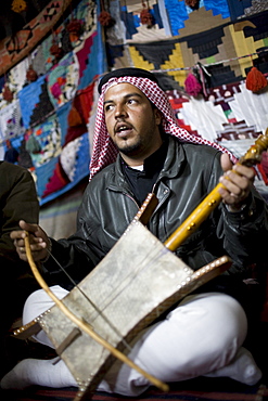 Palmyra, Syria - January, 2008: Bedouin man playing a traditional instrument.