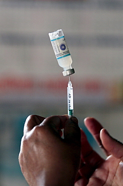 A heath care official prepares an injection in the small town of Dhulikhel, outside Kathmandu, Nepal.