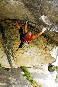 A woman rock climbing in Yosemite Valley, California, USA.