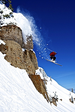 A man skis off a cliff in Wyoming.