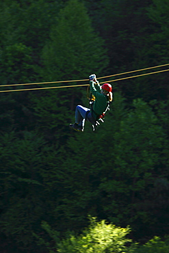 A woman zips through the forest canopy during a forest tour near Asheville, North Carolina.