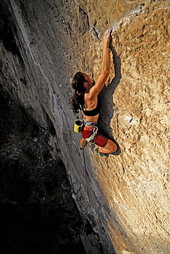 A rock climber ascends a steep rock face in Mexico.