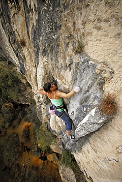 A rock climber ascends a steep rock face in Mexico.