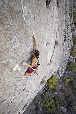 A rock climber ascends a steep rock face in Mexico.