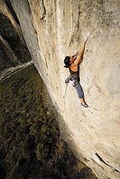 A rock climber ascends a steep rock face in Mexico.