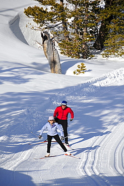 A man and woman cross country ski at Kirkwood Mountain Resort, California.