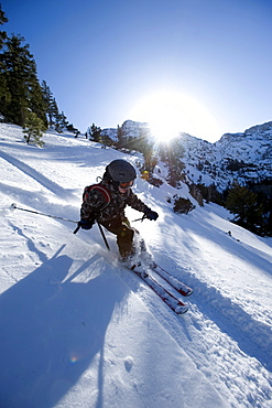 A boy skies down a hill in the California backcountry.