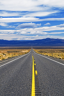 Highway 50, The Loneliest Road in America, disappears into the distance in the Nevada desert.