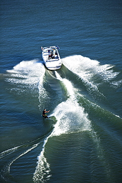 A athletic wakeboarder carves and slashes on a calm day in Idaho. Shot from above.