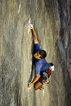 Yon Lambert bears down on tiny holds on Pawing The Void (5.12b/c) on the Southwest face of Cedar Rock near Brevard, NC