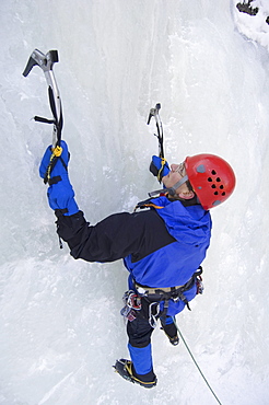 man ice climbing