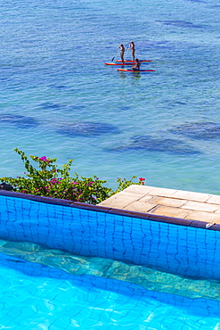 People travels by sup surfboards at coastline of Nusa Lembongan and Nusa Ceningan islands, Indonesia.