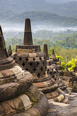 Sunrise at the Buddhist stupa and temple complex, Borobudur. Borobudur was completed in 825 AD and is currently a UNESCO World Heritage Site.