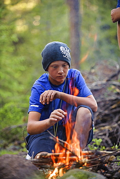 A boy builds a fire in preparation to spend the night out and earn the WIlderness Survival Merit Badge, at the end of Troop 693's six day backpack trip through the High Uintas Wilderness Area, Uintas Range, Utah