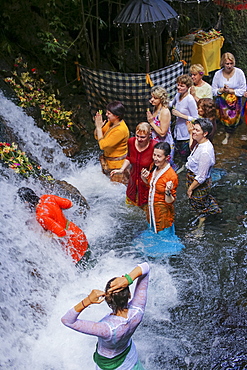 Balinese ceremony in waterfall,Bali,Indonesia.