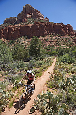 Woman rides the Submarine Rock Loop in South Sedona, Arizona. The trail has everything from slickrock to single track to stairs that lead to Submarine Rock.