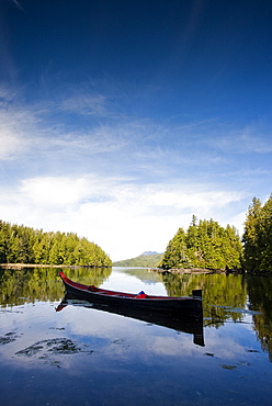 A canoe, carved with the traditions of the native peoples of Vancouver Island, in a small inlet near Tofino, Canada