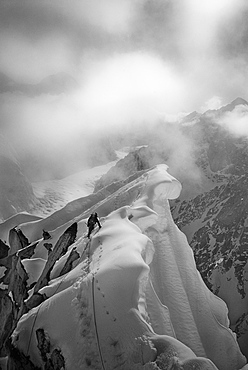 CJ Pearson navigates the knife-edged and corniced ridge of Peak 11,300 in the Alaska Range, United States of America