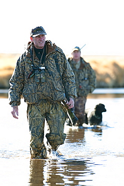 Brad Jackson and Corey Funk hunt ducks with their dog Grizzly in Carson City, NV, United States of America