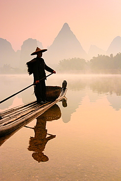 Chinese fisherman fishing in Li Jang River with cormorant birds, Guilin