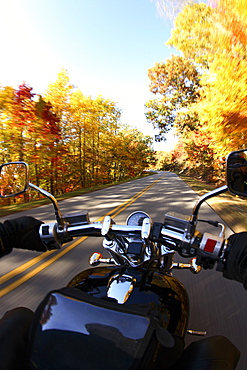 Motorcycle rider out for a cruise on a beautiful fall day on the Blue Ridge parkway south of Asheville, NC