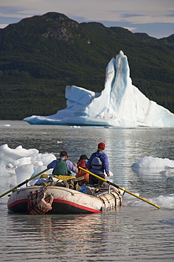 Raft negotiating icebergs in a lake in Alaska, United States.