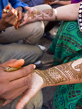 Henna being applied on woman's hand in Jaipur, Rajasthan, India