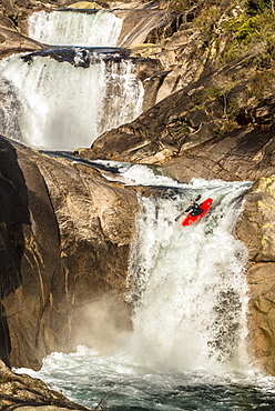 Spanish whitewater kayaker Aniol Serrasolses is dropping down the last waterfall of a triple set on the Rio Castro Laboreiro.