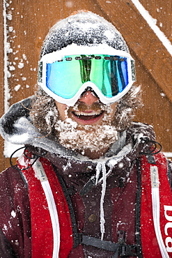 Portrait Of Happy Male Snowboarder During Snow