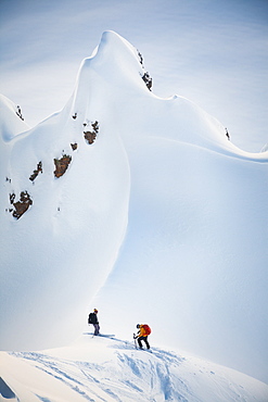 Two Skiers Preparing To Ski On Gargoyles Near Elfin Lakes In Garibaldi Provincial Park, Canada